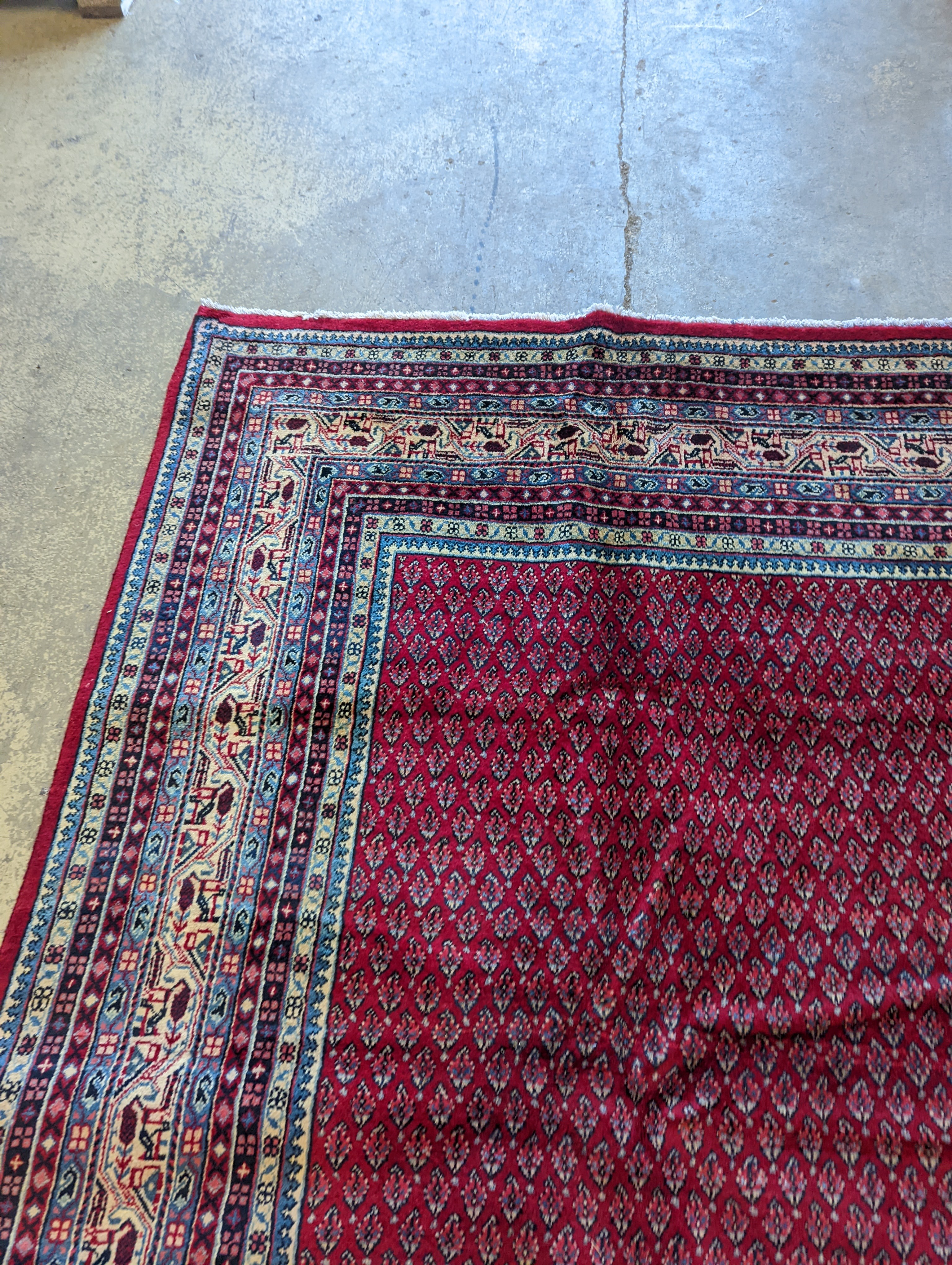 An Araak crimson ground carpet, 350 x 250cm